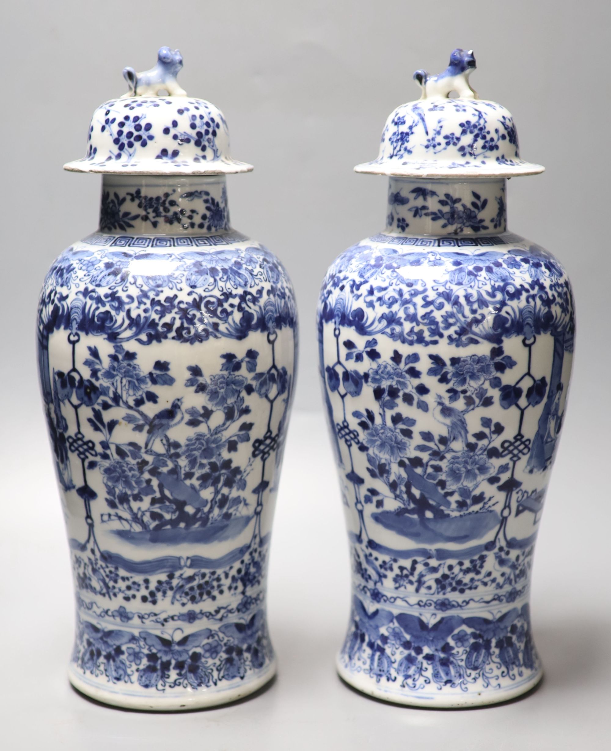 A pair of Chinese blue and white baluster vases and covers, Kangxi marks, late 19th century, 39.5cm high